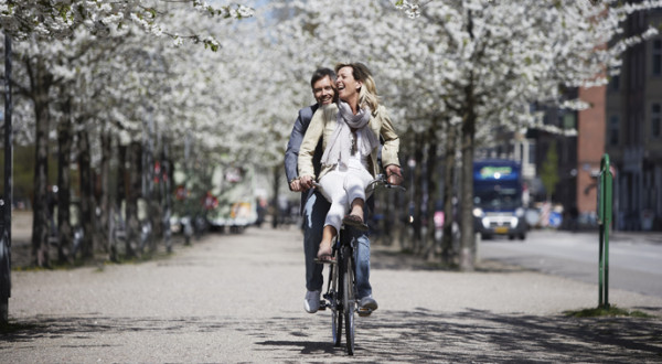 Man riding with girlfriend on bicycle